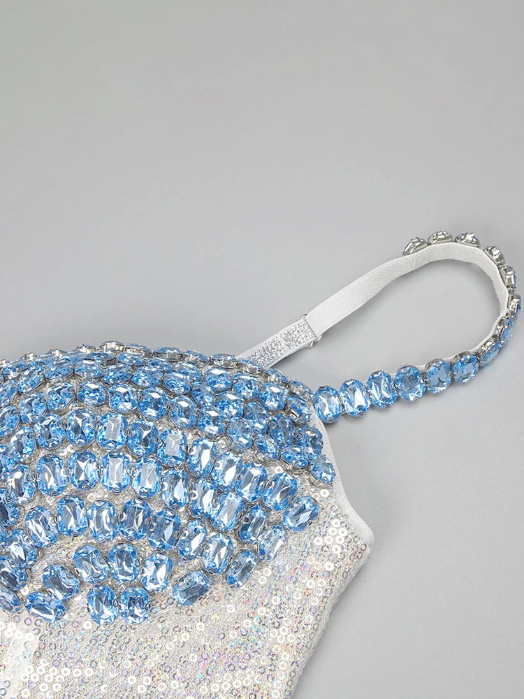 Sparkling handbag with blue and silver beading on a light gray background