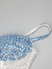 Sparkling handbag with blue and silver beading on a light gray background