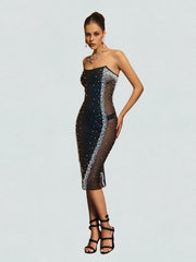 Woman wearing a black sequin dress on a light gray background