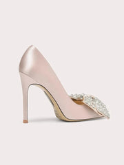 Pink high-heeled shoe with embellishments on a light gray background