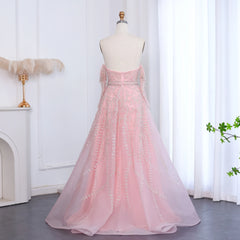 Pink evening gown on a mannequin against a white curtain background