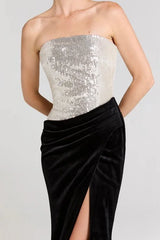 Close-up of the sequined bodice and draped velvet skirt with high slit detail
