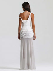 Woman wearing a white one-shoulder dress on a plain background