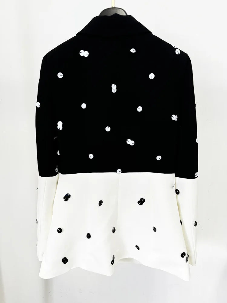 Black and white polka dot blouse on a mannequin against a white background