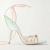 Strappy pointed toe thin heel ankle wrap sandal in mint green and pale pink.
