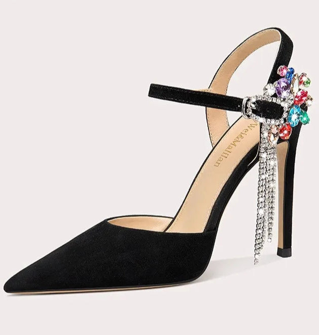 Black high-heeled shoe with colorful embellishments on a light gray background