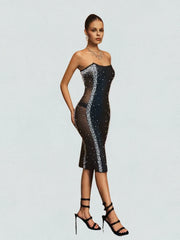 Model wearing a black sequin dress on a light gray background
