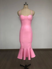 Pink dress on a mannequin against a plain background