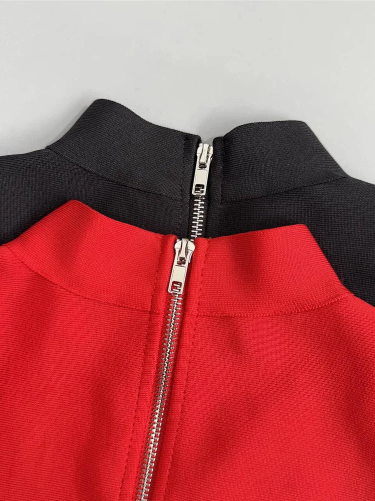 Close-up of a red and black garment with a zipper on a gray background