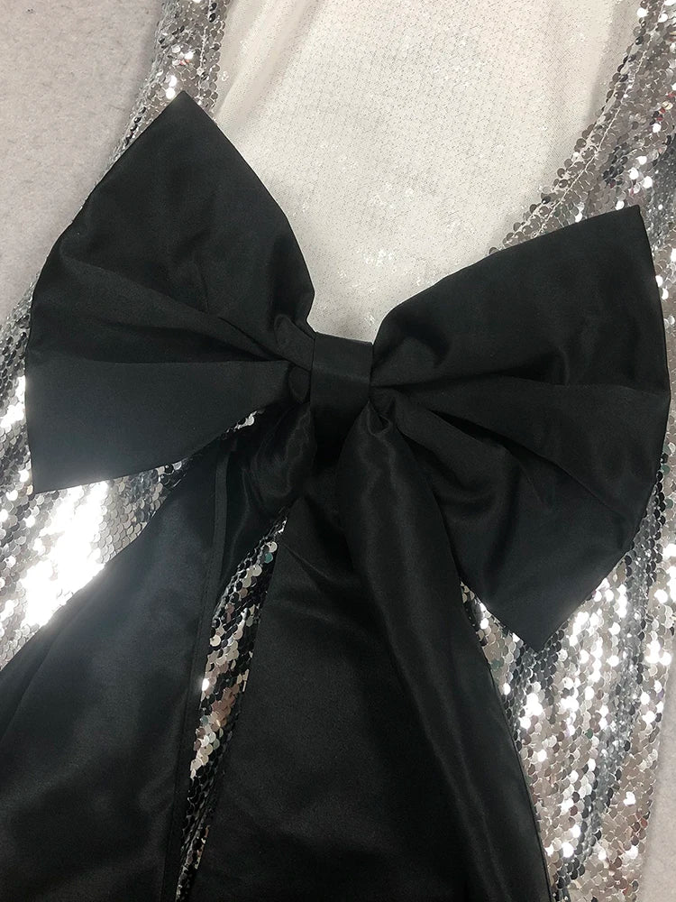 Black bow tie on a sequined background