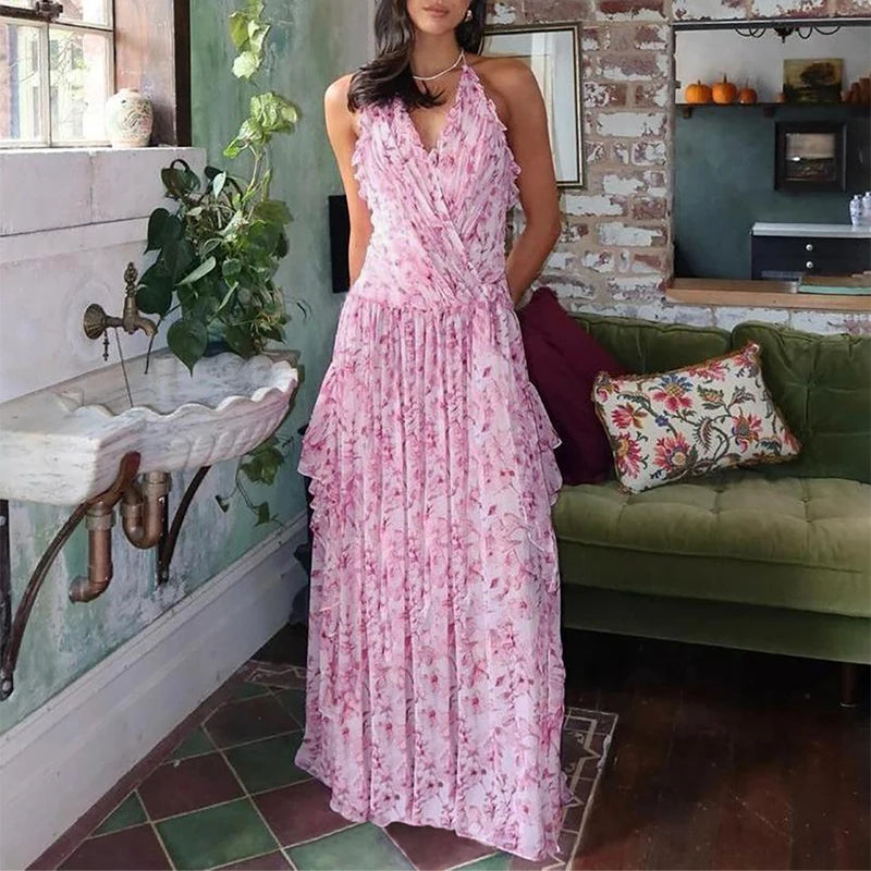 Woman wearing a pink floral dress in a room with a green couch and sink.