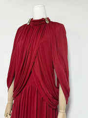 Red draped dress on a mannequin against a white background