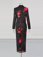 Black dress with red floral patterns on a mannequin against a white background