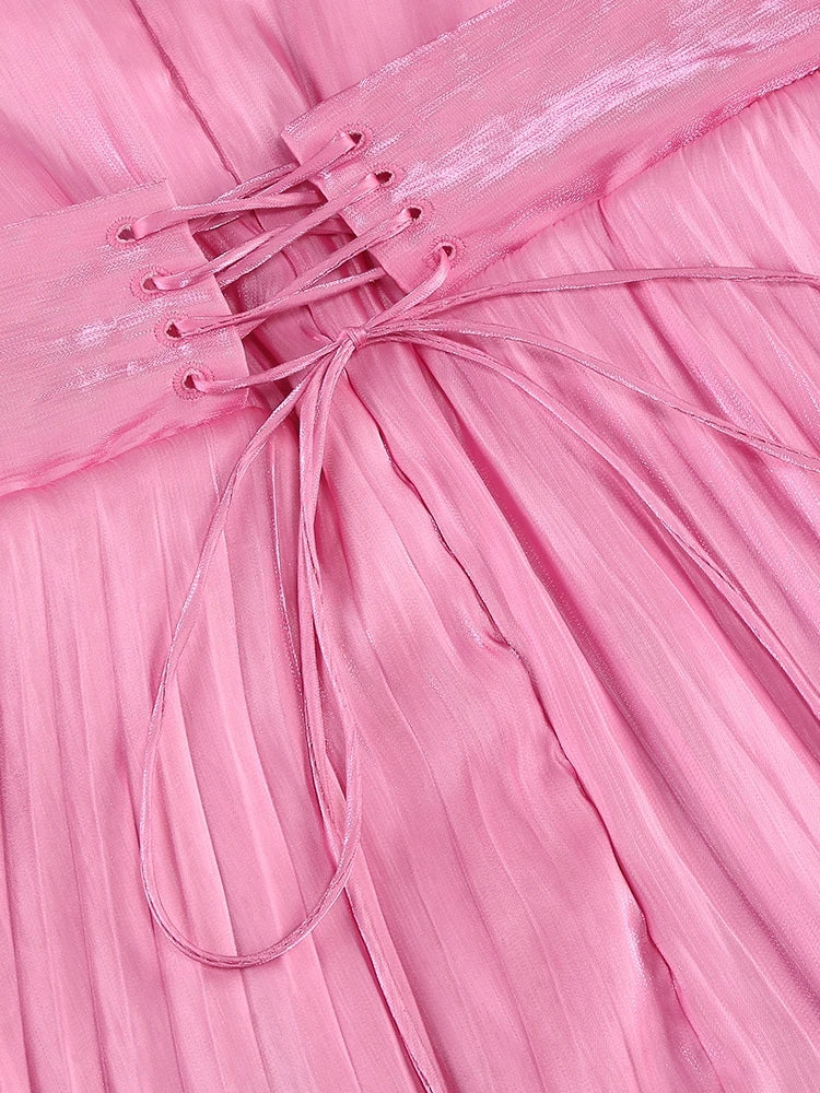 Close-up of a pink pleated fabric with a bow detail