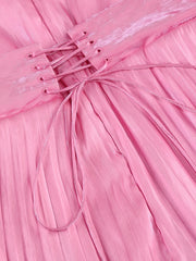 Close-up of a pink pleated fabric with a bow detail