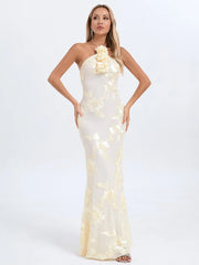 Woman wearing a white evening gown with floral details on a white background