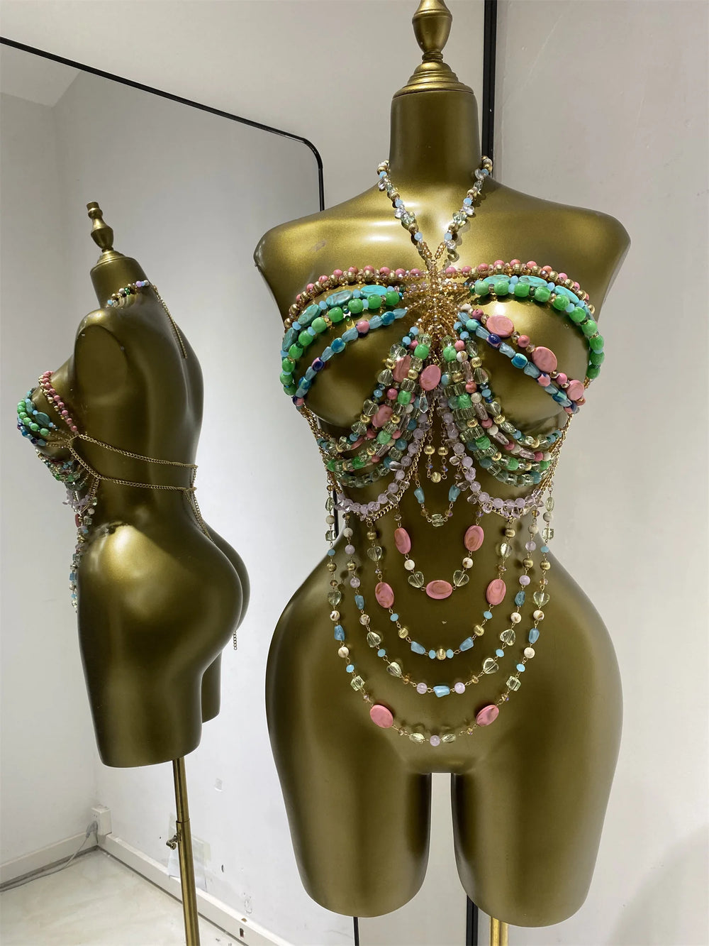 Multi-layer beaded body chain swimwear set with cascading strands in green, blue, and pink.