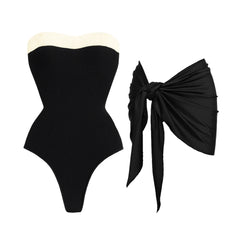 Textured black swimsuit with cream trim and black sarong.