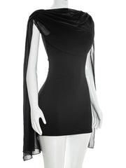 Mannequin displaying a black mini dress with draped cowl neckline and capelet sleeves, front view.