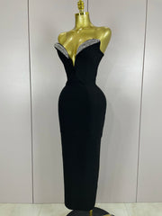 Black evening gown with beaded neckline on a mannequin against a plain background