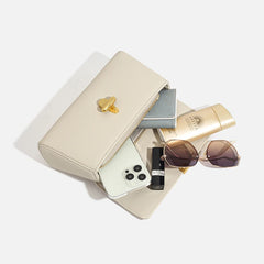 Open cream genuine leather shoulder bag showing contents