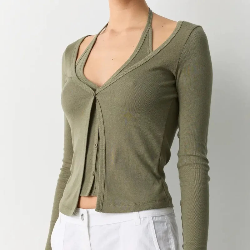 Green long-sleeve top worn by a person on a plain background