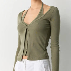 Green long-sleeve top worn by a person on a plain background