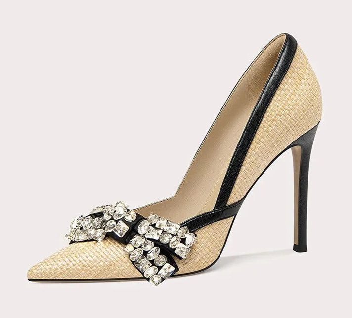 High-heeled shoe with decorative strap on a light gray background