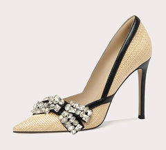 High-heeled shoe with decorative strap on a light gray background