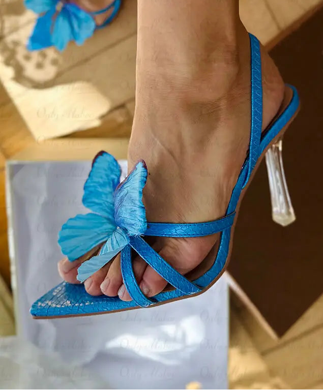 Close-up of a butterfly strap clear heel sandal