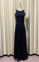 Navy blue evening pant suit on a mannequin against a white curtain background