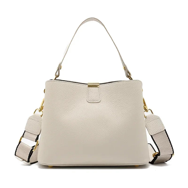Beige handbag with gold accents on a white background