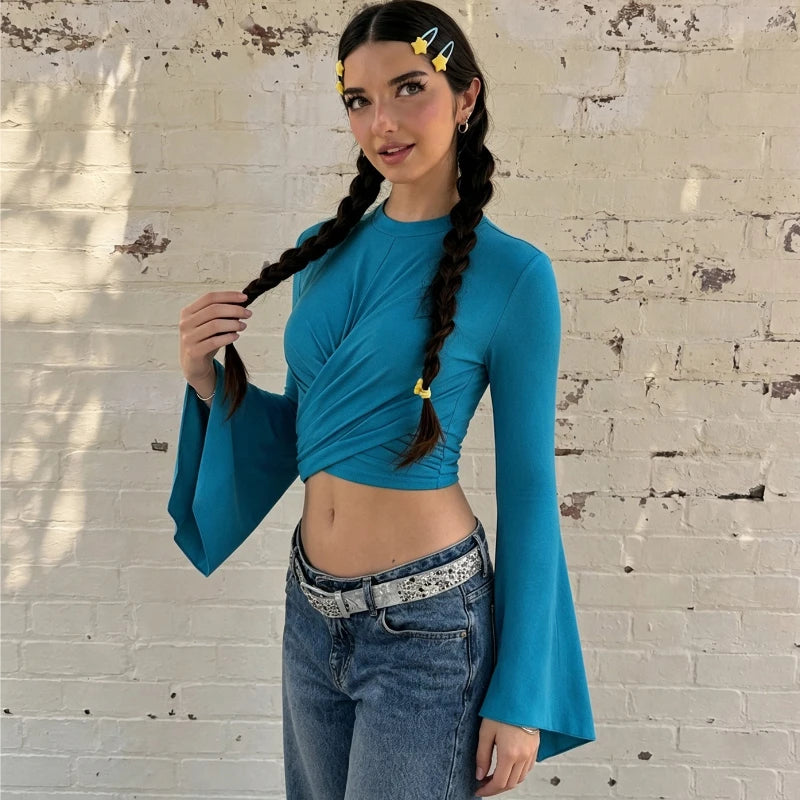 Close-up of a blue twist front flare sleeve crop top