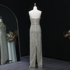 Silver sequin evening gown on a mannequin against a black background