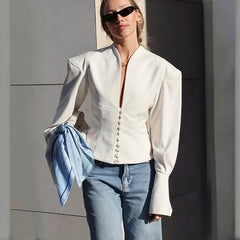 White v-neck slim-fit blazer with button front and full sleeves, styled with blue jeans