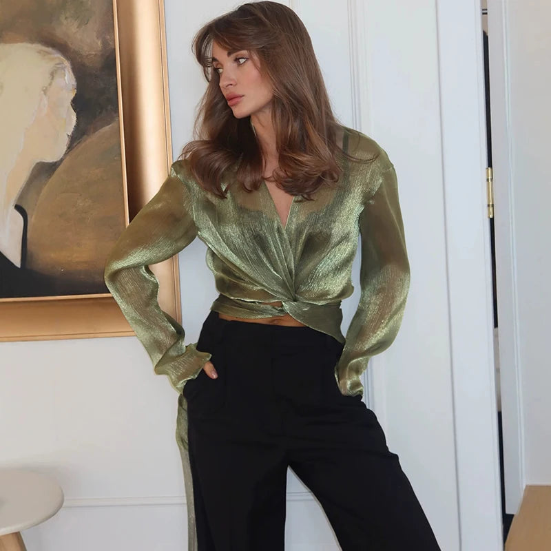 Model wearing a green glitter wrap front long sleeve shirt