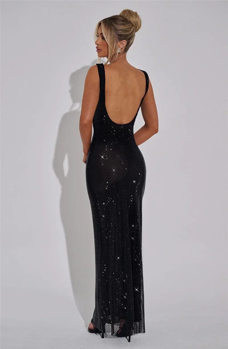 Woman wearing a black sequin gown against a white background