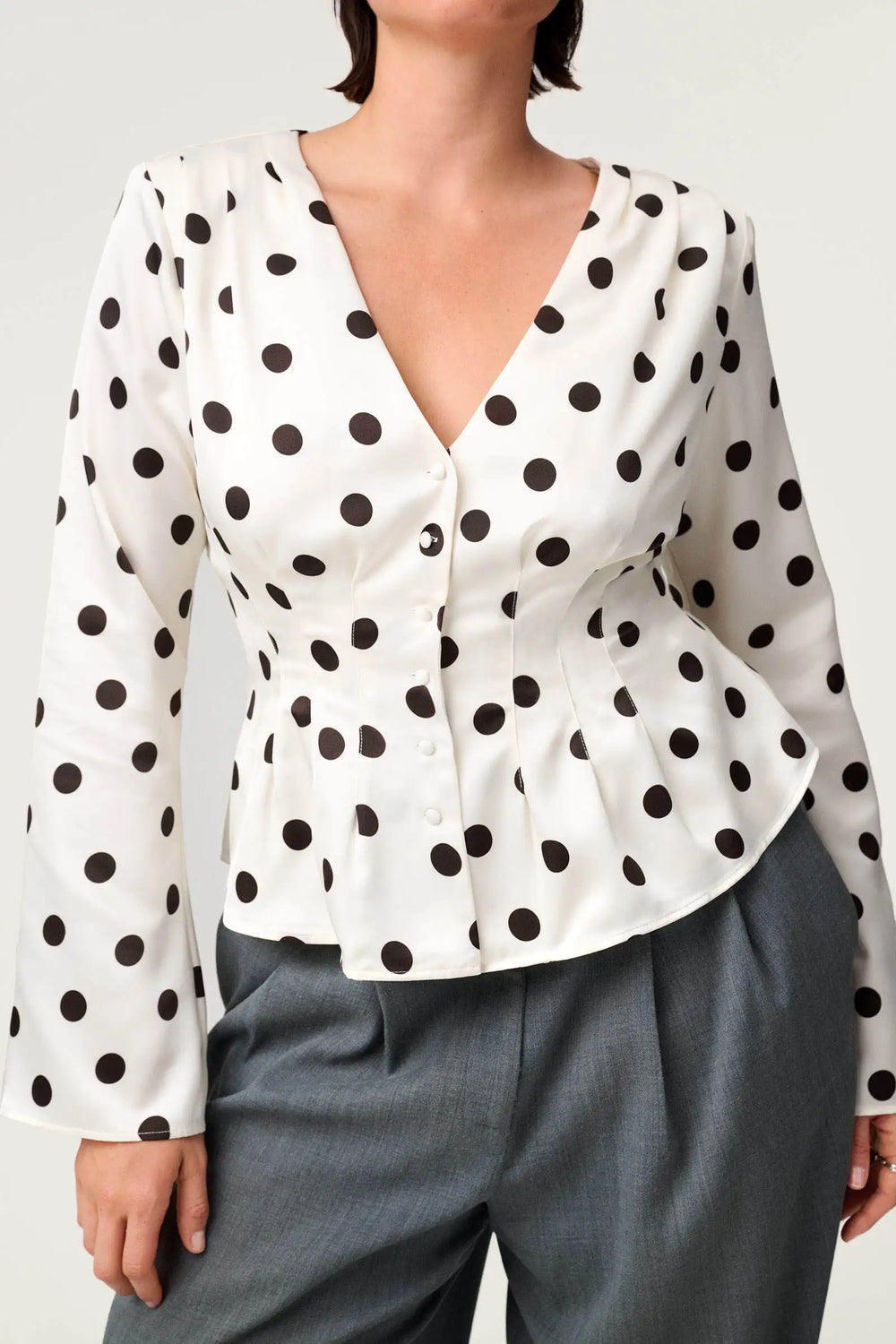 Polka dot ruched waist v-neck peplum top detail view