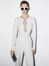 White long-sleeve jumpsuit with rhinestone embellished sweetheart cutout