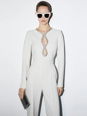 White long-sleeve jumpsuit with rhinestone embellished sweetheart cutout