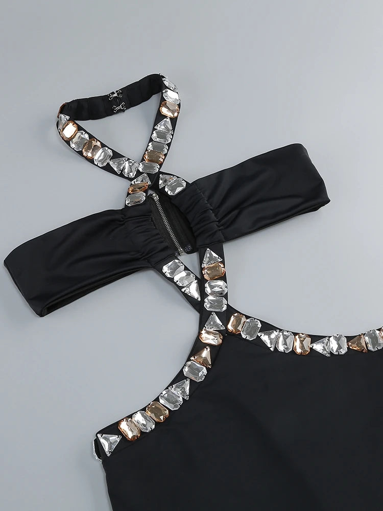 Black halter top with crystal embellishments on a gray background