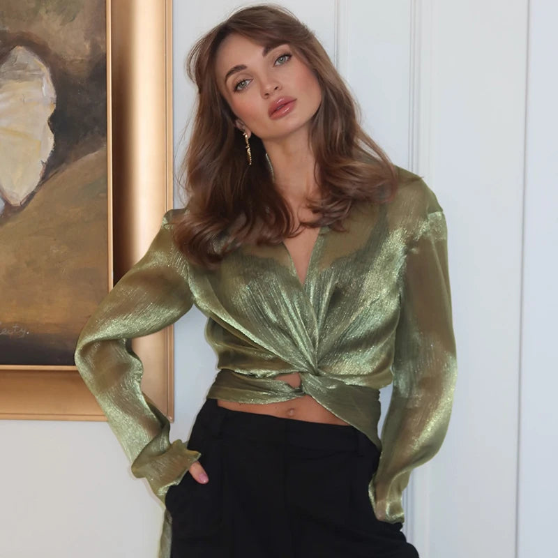 Close-up of green glitter wrap front long sleeve shirt