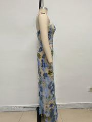 Mannequin wearing a floral dress against a plain white wall.