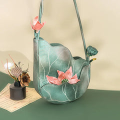 Green floral-patterned bag with pink flowers on a green surface