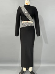 Black dress with silver embellishments on a mannequin against a gray background