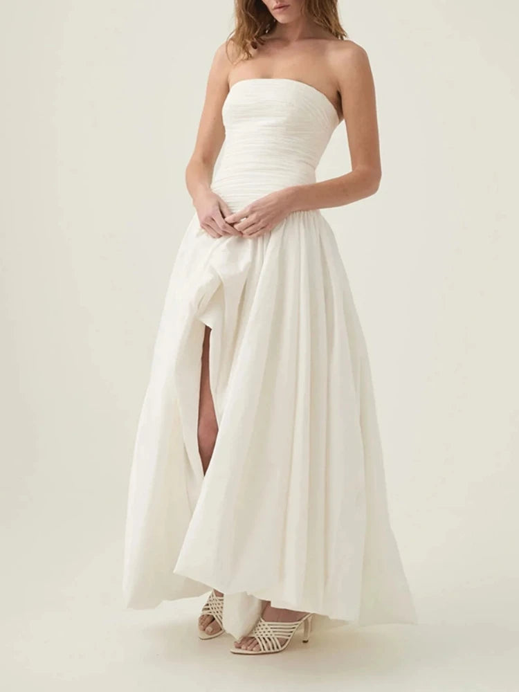 Woman wearing a strapless white dress on a white background