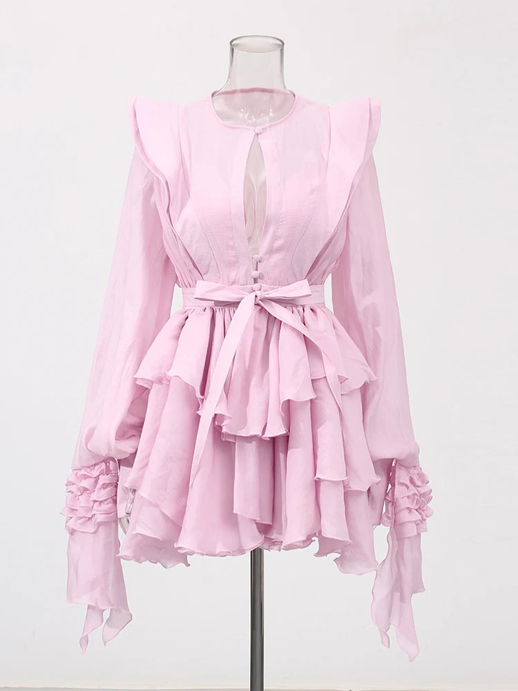 Pink ruffled dress on a mannequin against a white background