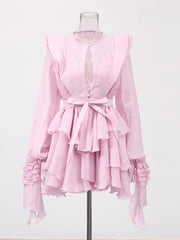 Pink ruffled dress on a mannequin against a white background