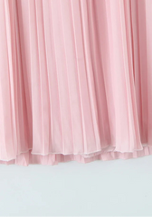Pink pleated fabric against a light gray background