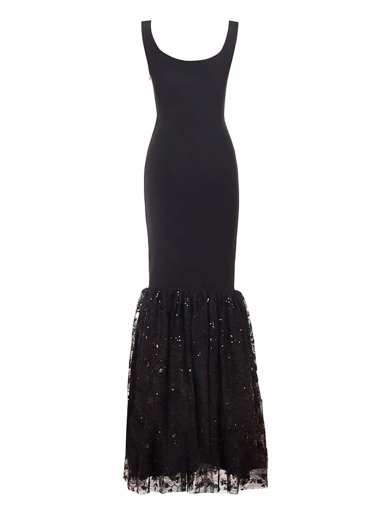 Black dress with a sheer, embellished bottom half on a white background